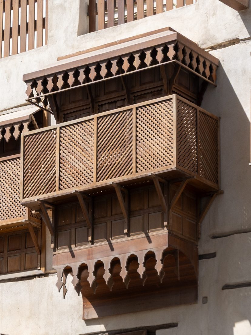 A wooden roshan on a coral-stone wall in Historic Jeddah